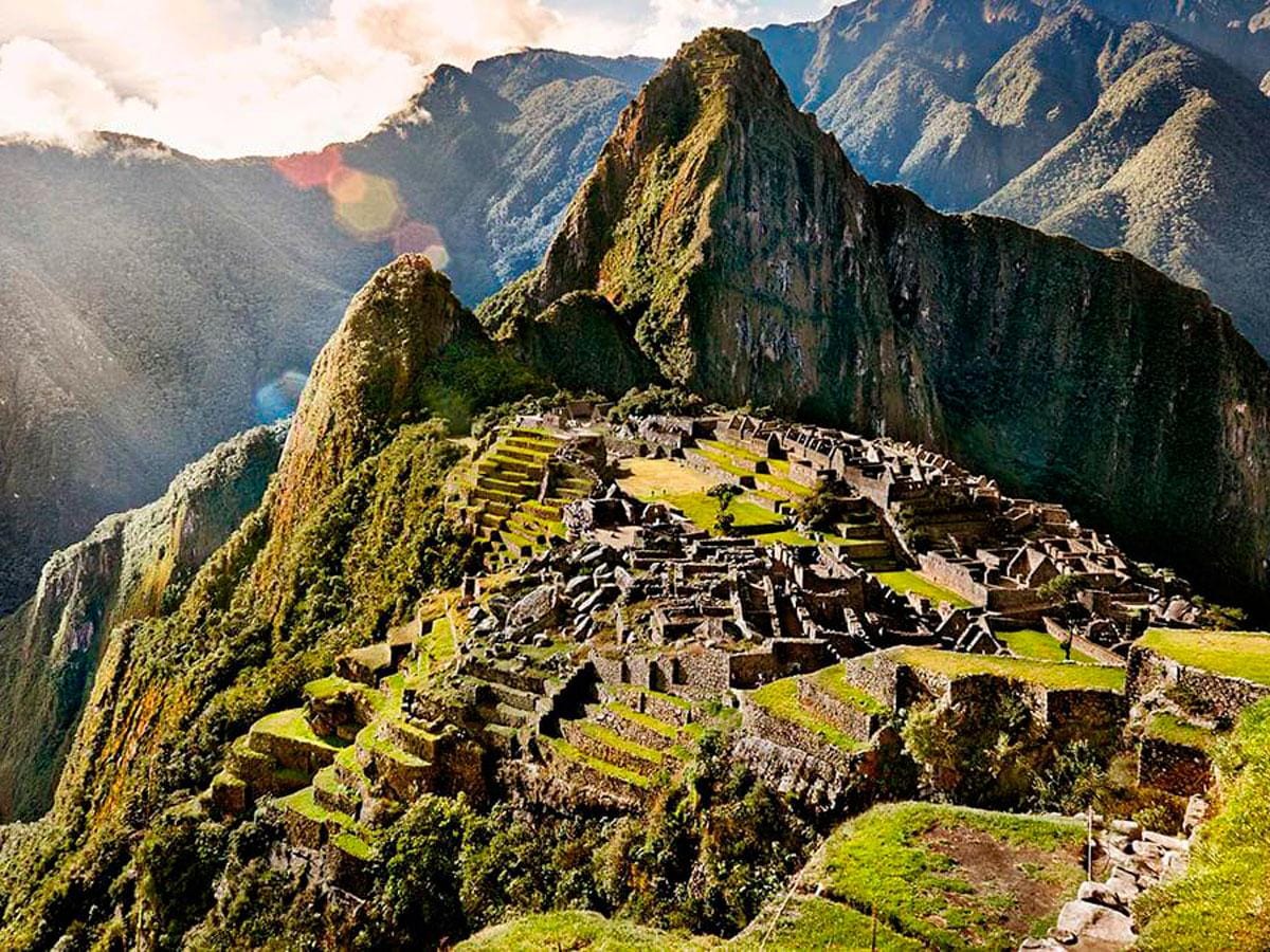Sacred ruins of Machu Picchu shrouded in mist at sunrise, radiating ancient spiritual energy and high-frequency transformation.