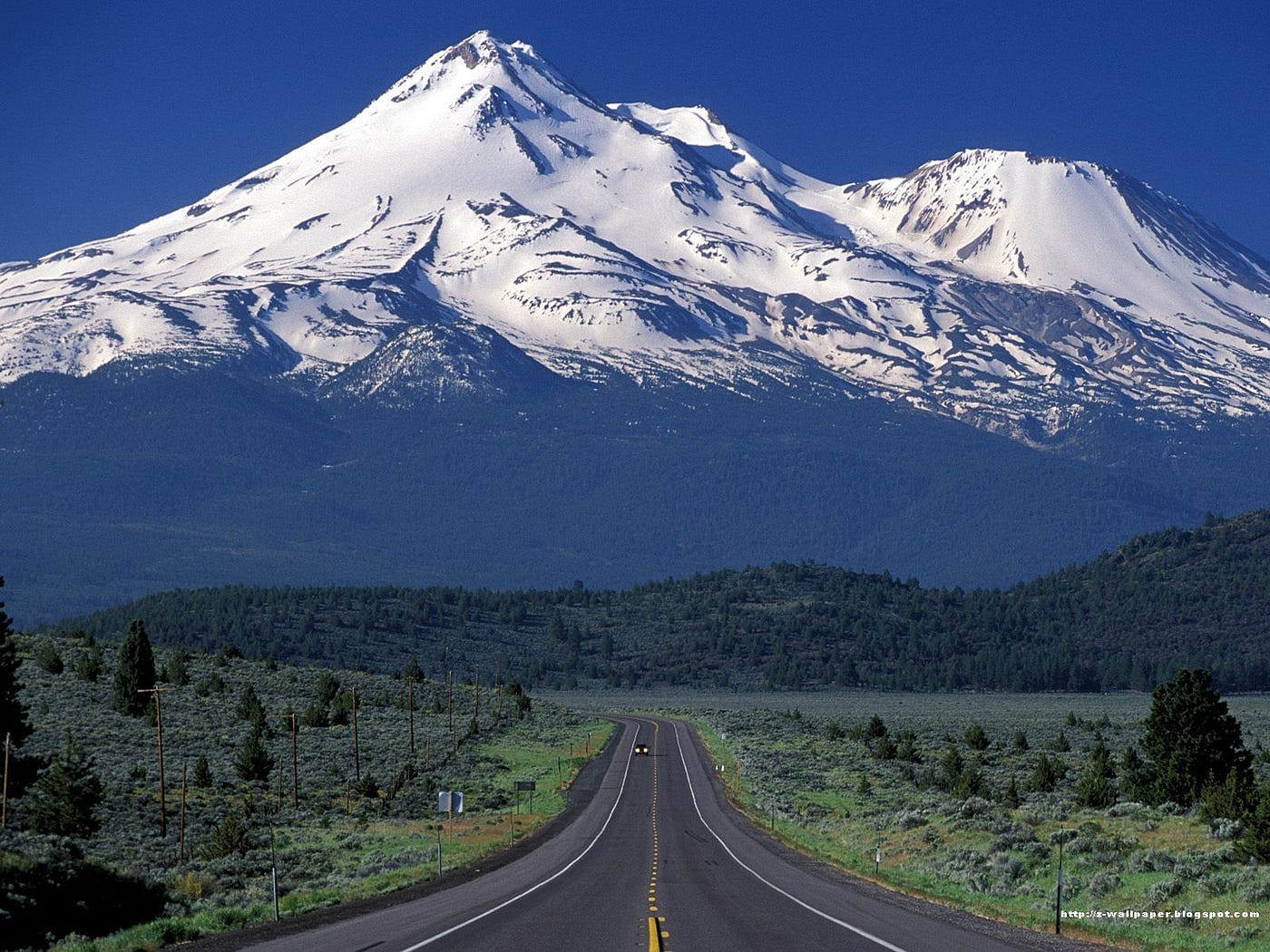 Snow-capped Mount Shasta rising above the clouds, a sacred vortex in California known for spiritual awakenings and energy alignment.