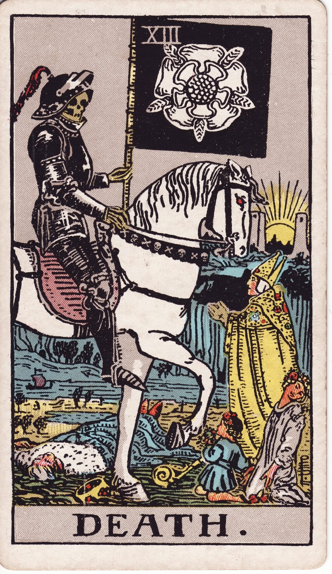 Death tarot card (Rider–Waite–Smith): skeletal rider on white horse with black flag (white rose); figures fall and kneel as sun rises—endings, transformation, rebirth.