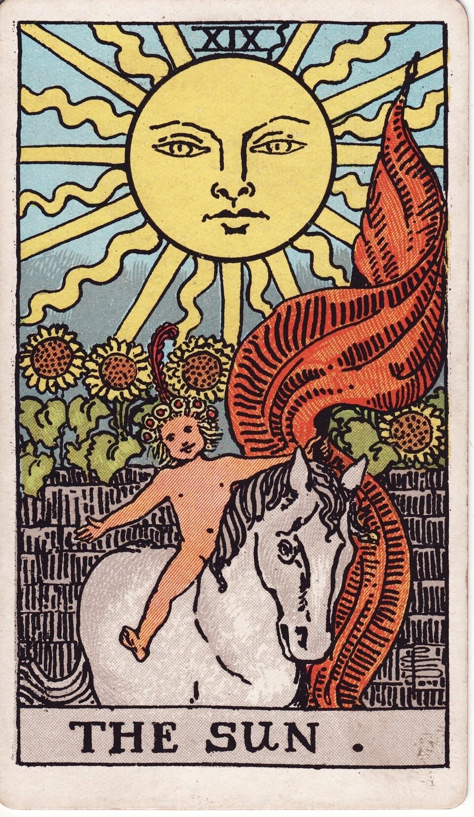 The Sun tarot card (Rider–Waite–Smith): radiant sun above child on white horse with red banner, sunflowers behind—joy, clarity, vitality, success.