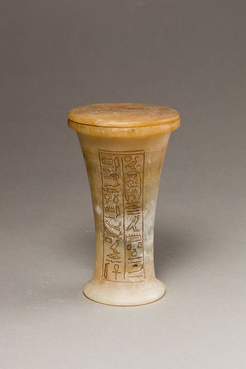 Ancient Egyptian alabaster unguent jar with hieroglyphic inscription, used for ritual oils and perfumes