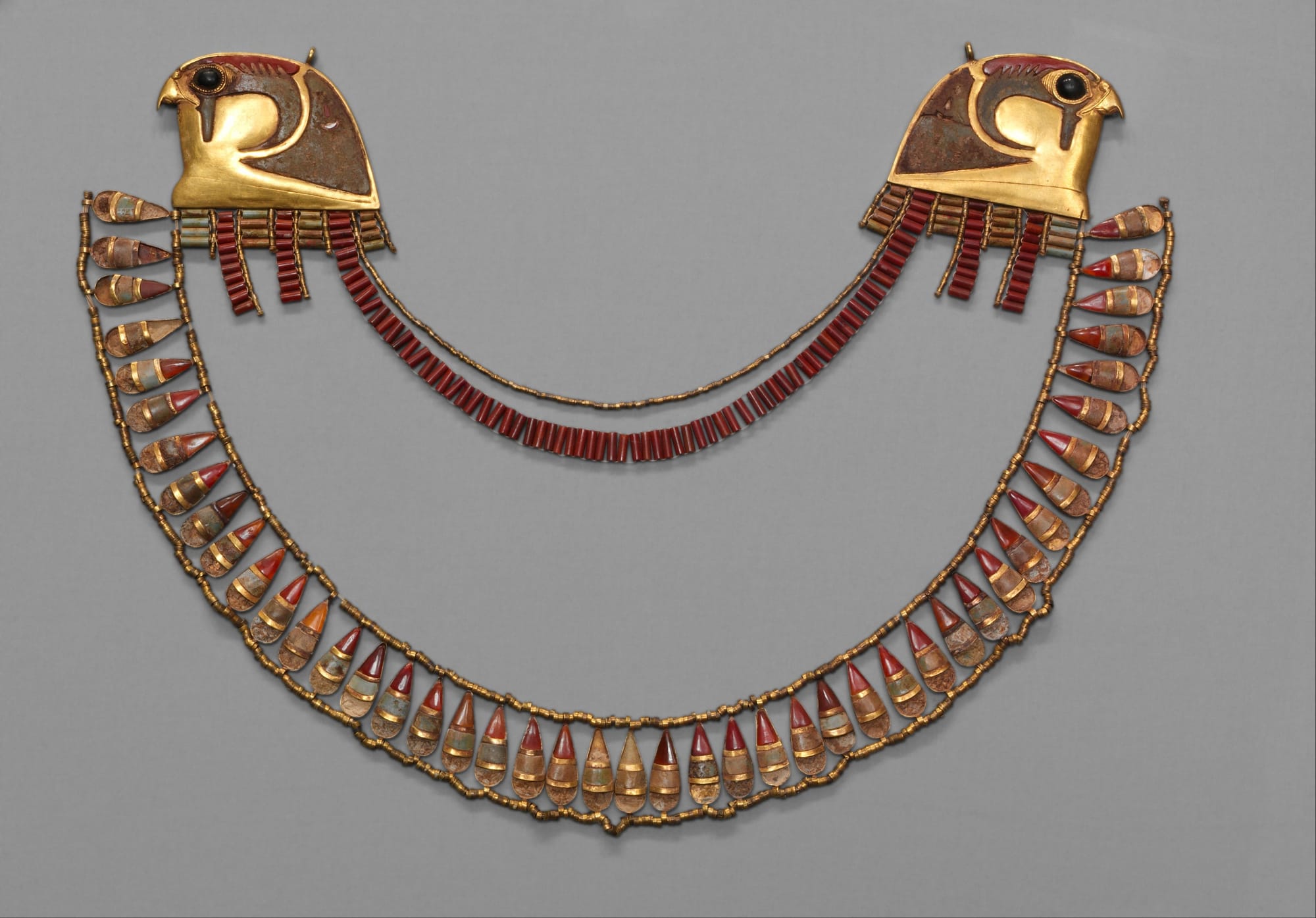 Ancient Egyptian broad collar with falcon heads symbolizing royal authority and protection.