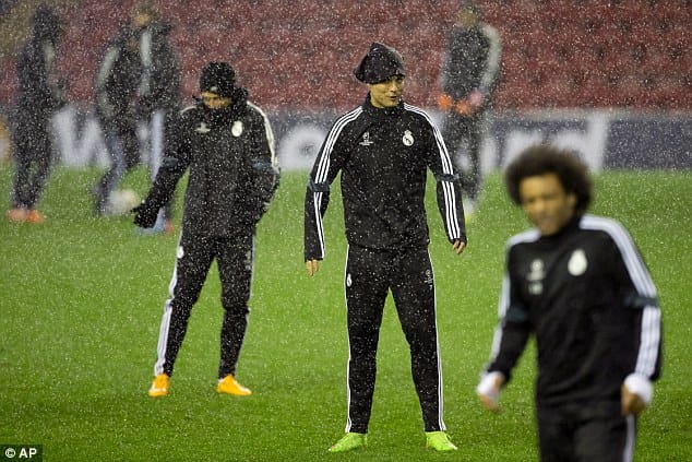 Cristiano Ronaldo training in heavy rain with Real Madrid, maintaining focus and discipline despite harsh conditions