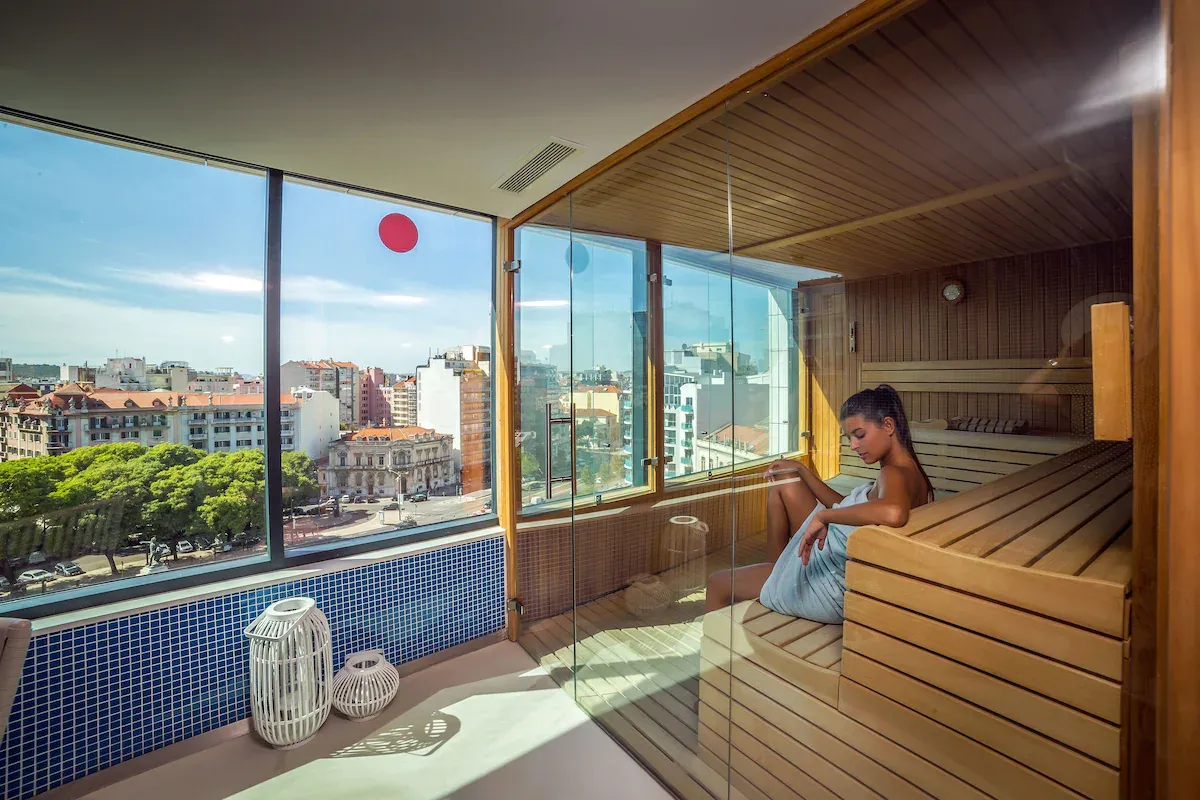 Modern sauna with city views at EVOLUTION Lisboa Hotel â a grounding wellness space to reset your energy for faster manifestation.