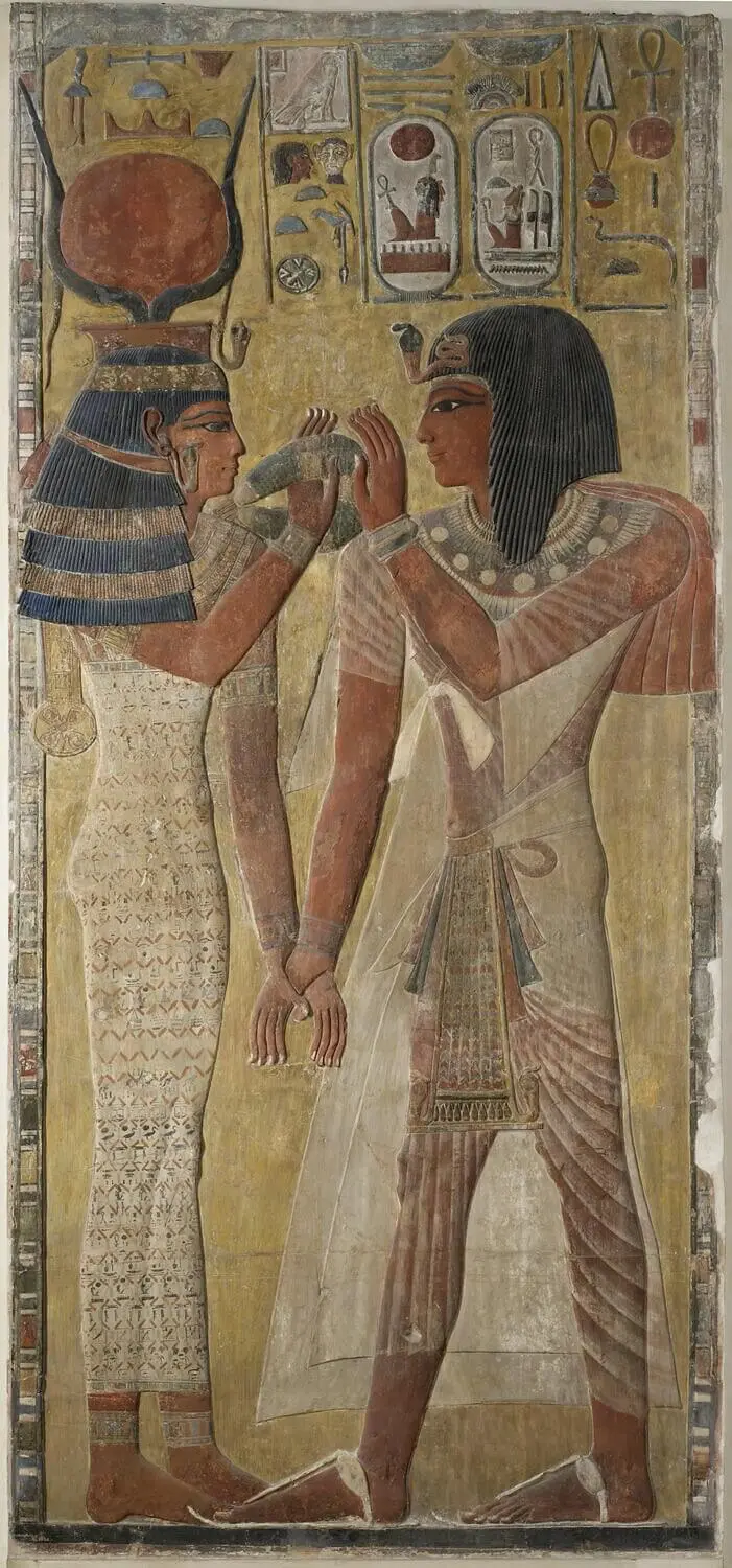 Egyptian wall relief depicting ritual anointing under the protection of the goddess Hathor, associated with scent, beauty, and divine embodiment