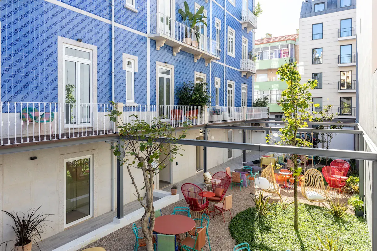 Haws Lisboa boutique courtyard with colorful design â a minimalist calm space ideal for deep manifestation work and identity shifts.