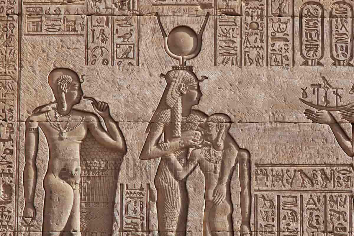 Ancient Egyptian relief of Isis nurturing Horus, symbolizing divine feminine power