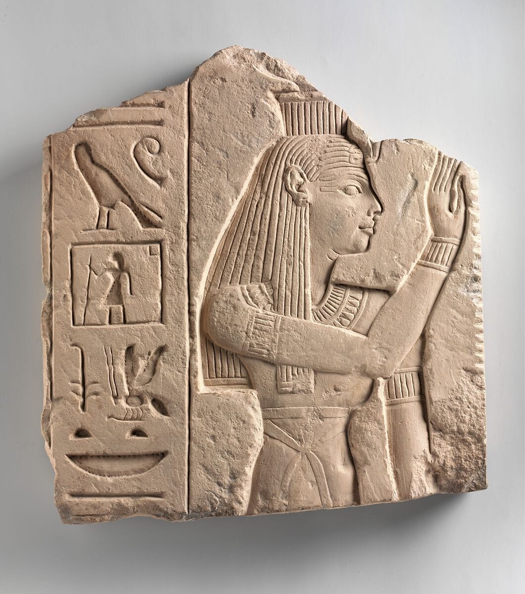 Stone relief of the goddess Isis in calm devotional posture, ancient Egypt