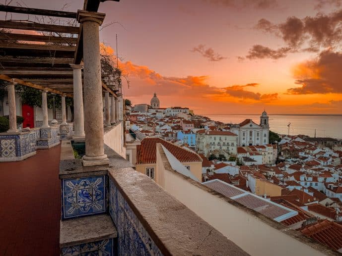 Sunset over Lisbon rooftops from a historic miradouro overlooking the Tagus River
