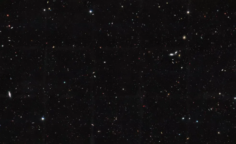 Dark field of distant stars against deep black space