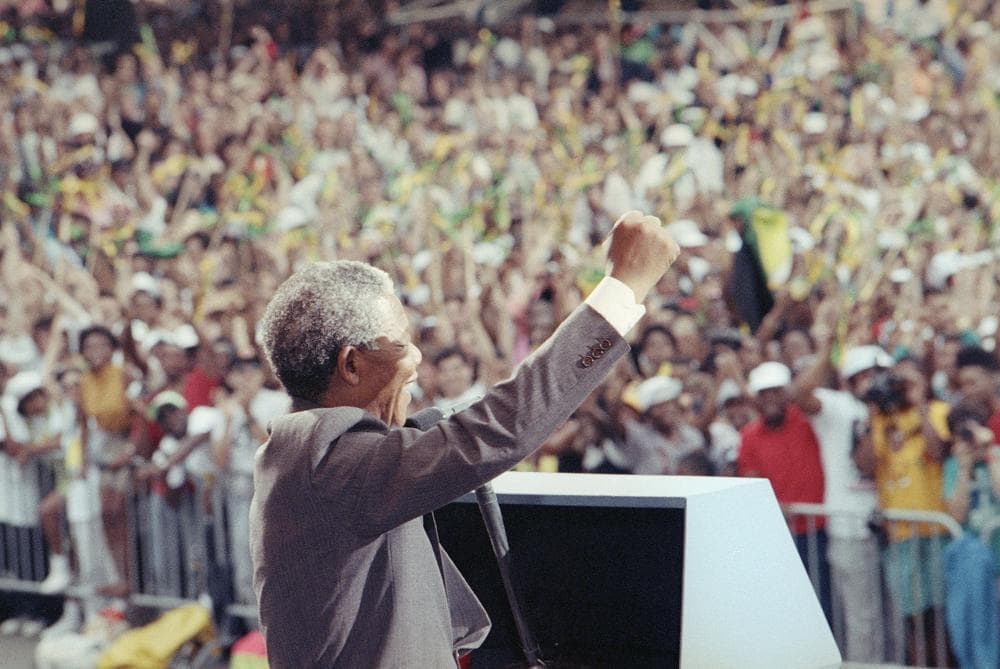 Nelson Mandela surrounded by South Africans, embodying Ubuntu and collective reconciliation