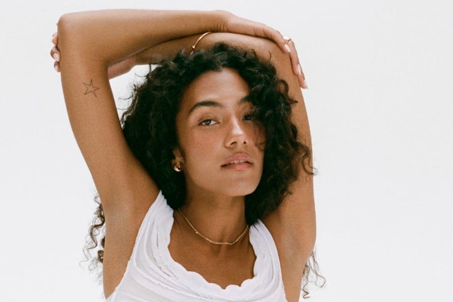 Olivia Dean portrait expressing feminine magnetism and manifestation through self-alignment, confidence, and soulful presence.