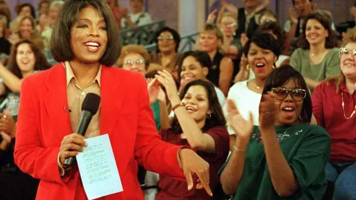 Oprah Winfrey speaking to a cheering audience on The Oprah Winfrey Show — early career success, intention, and manifestation in action
