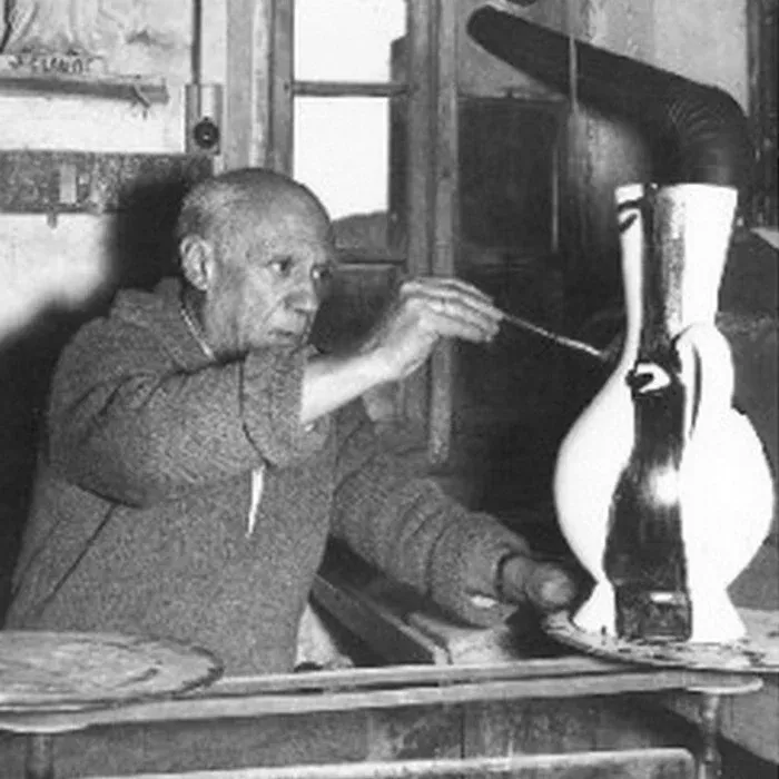 Pablo Picasso painting a ceramic vessel in Vallauris, embodying creative energy becoming form through focused presence