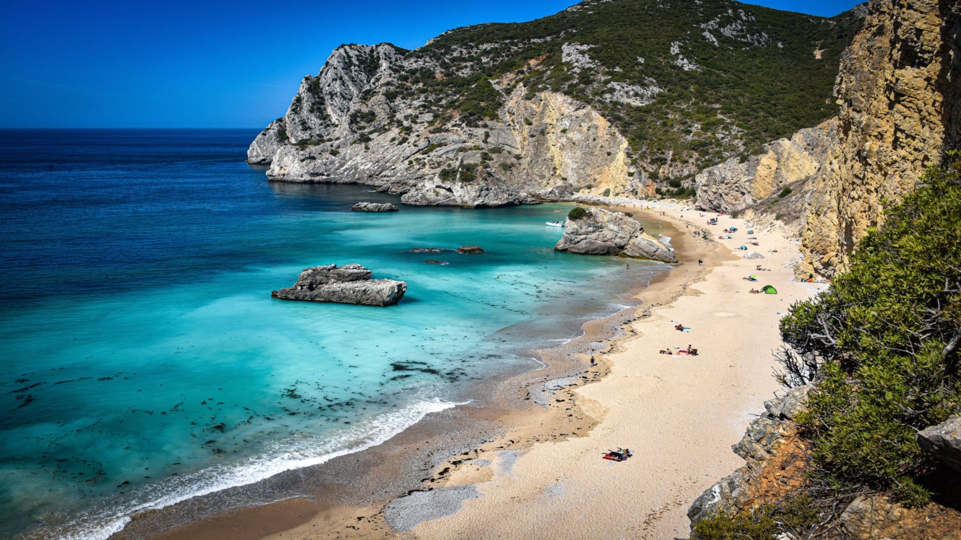 Praia do Ribeiro do Cavalo secluded beach near Sesimbra with turquoise water