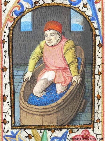 Medieval Book of Hours illustration of grape pressing in September, symbolizing transformation through pressure and alchemical labor