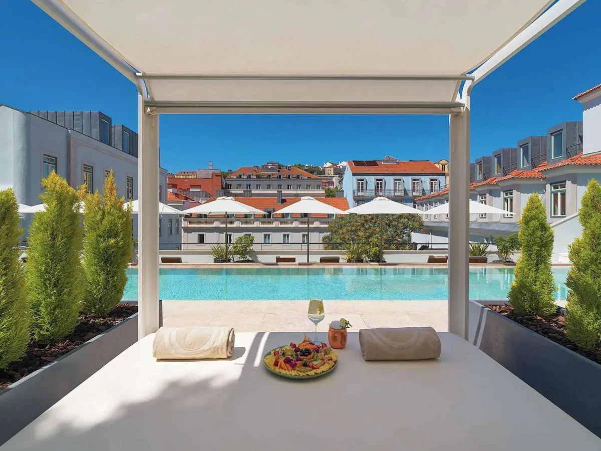 Luxury rooftop pool at The One PalĂĄcio da Anunciada in Lisbon â a soft-abundance manifestation hotel perfect for raising your vibration.
