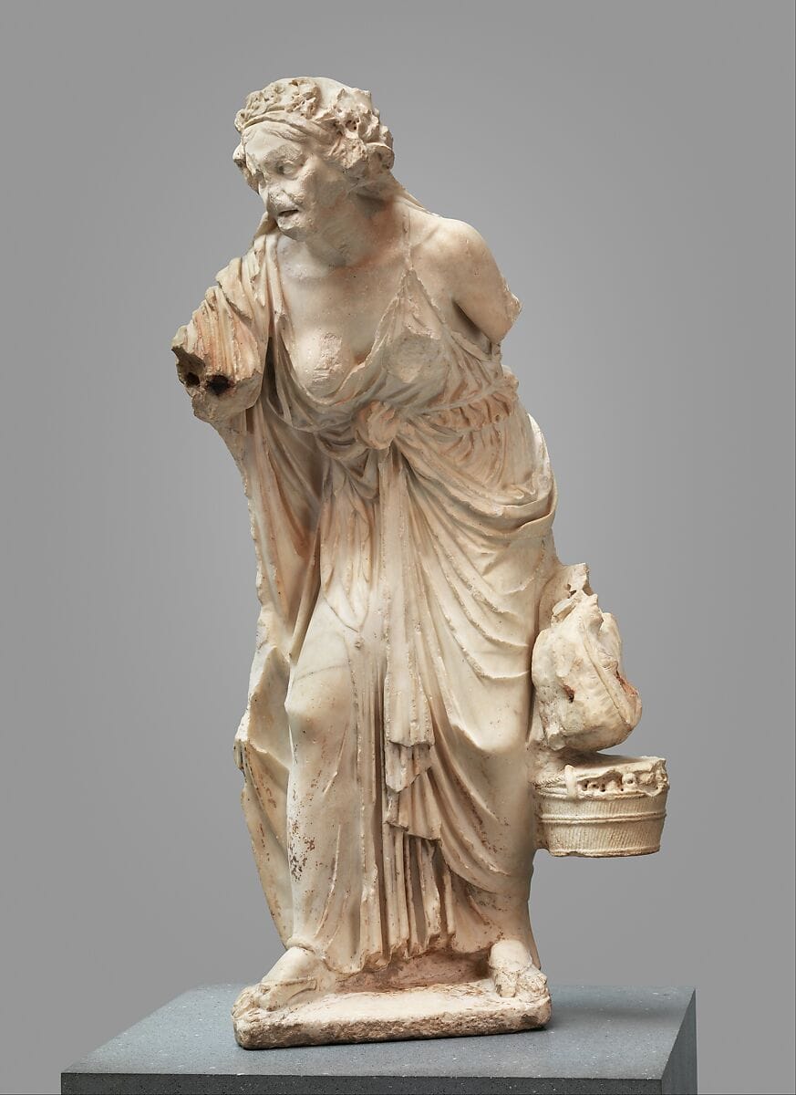 Roman marble statue of an elderly woman standing in a composed posture