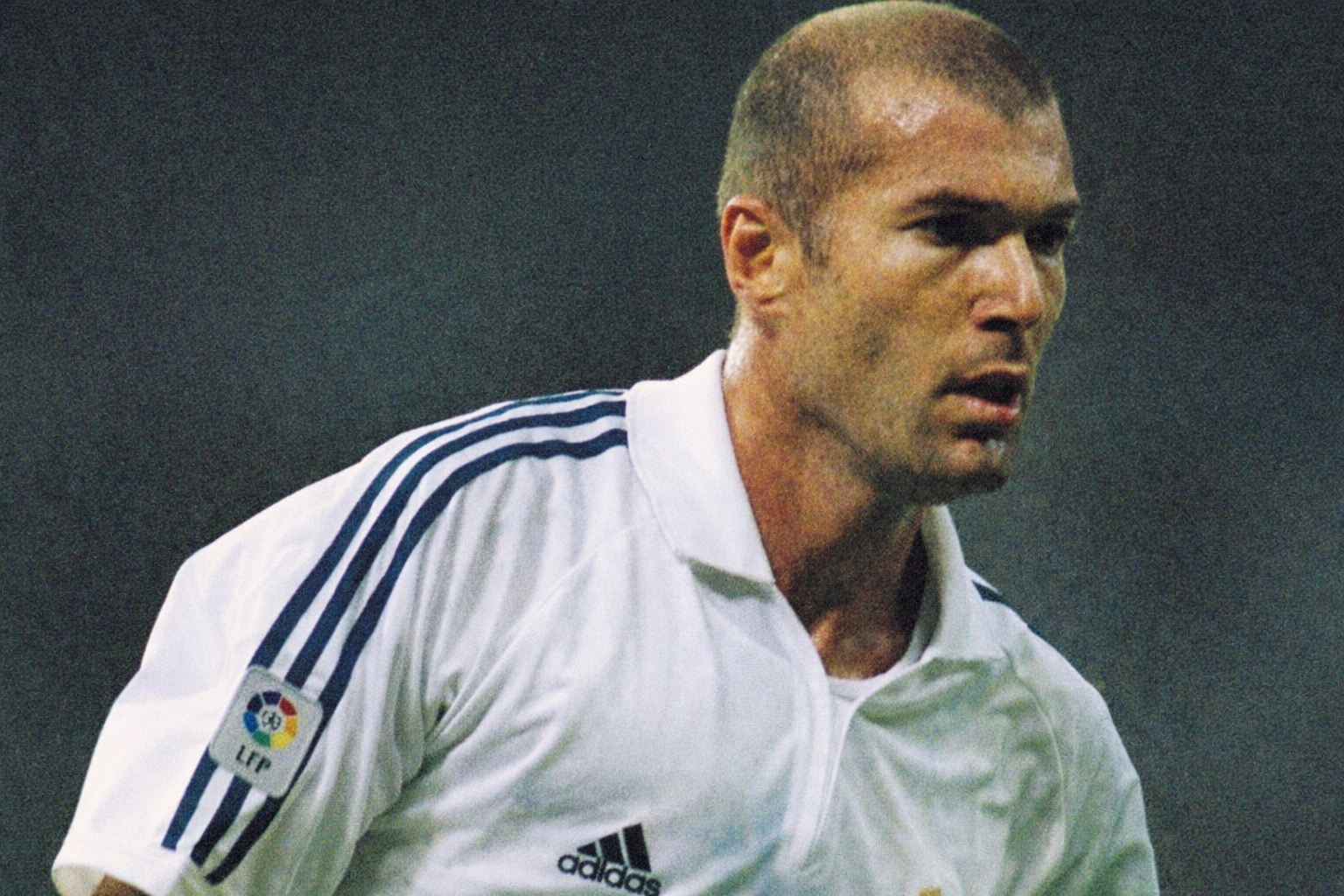 Zinedine Zidane standing composed and focused, expressing quiet authority and control through presence during a football match.
