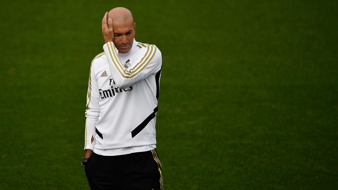 Zinedine Zidane standing alone in quiet reflection on the pitch, symbolizing presence, humility, and a lasting legacy beyond football.