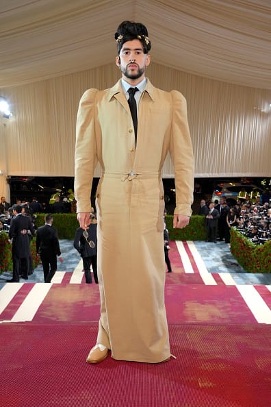 Bad Bunny wearing a tailored gown-inspired look at the 2022 Met Gala, publicly defying traditional gender and fashion norms.