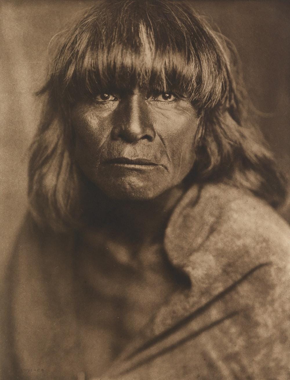 Black-and-white photographic portrait of a Hopi man by Edward S. Curtis, 1904.