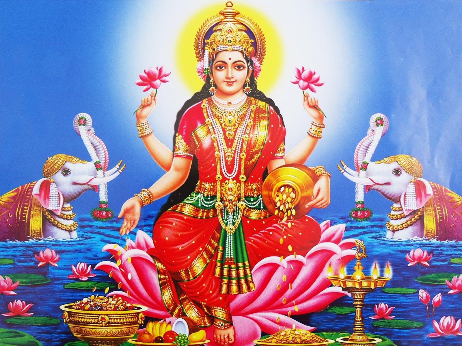 Gaja Lakshmi seated on lotus with elephants showering water and gold coins