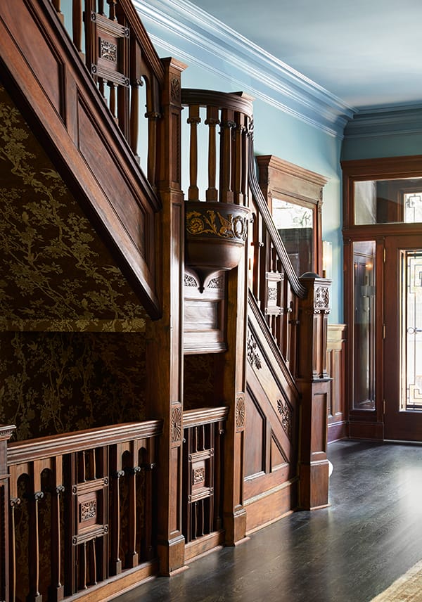 Interior staircase of a historic Harlem brownstone similar to the apartments where Abdullah taught students in 1930s New York