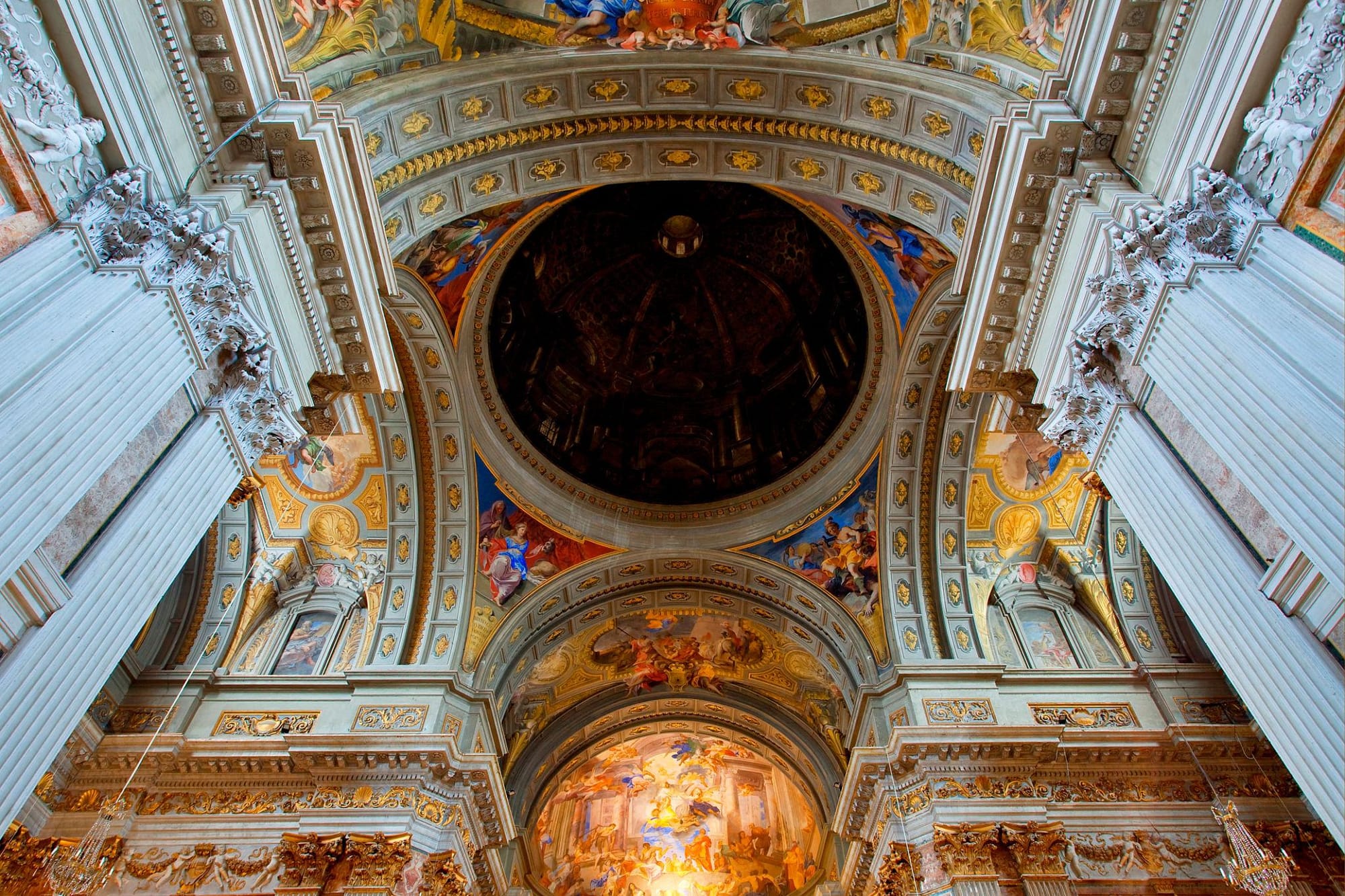 Illusionistic Baroque ceiling fresco inside the Church of St. Ignatius of Loyola in Rome symbolizing structural law and divine order