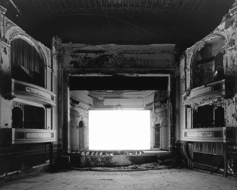 Long-exposure empty theater interior expressing stillness after identity change