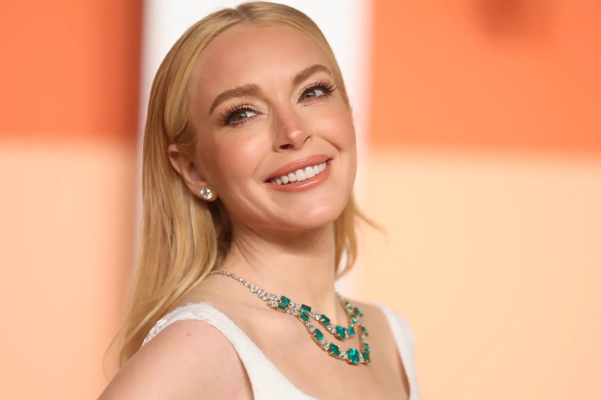 Lindsay Lohan portrait blonde hair green necklace glowing transformation manifestation mindset