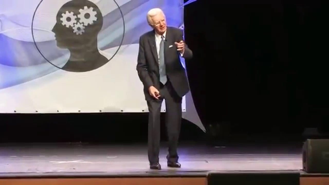 Bob Proctor explaining universal laws and the transmutation of energy during a seminar