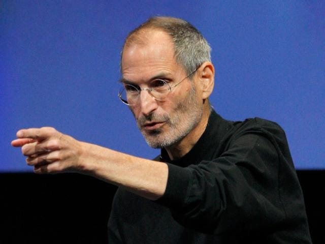 Steve Jobs presenting with intense focus and influence over audience.