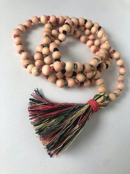 Japa mala beads resting on a sacred cloth, symbolizing mantra meditation, subconscious healing, and the power of manifestation.