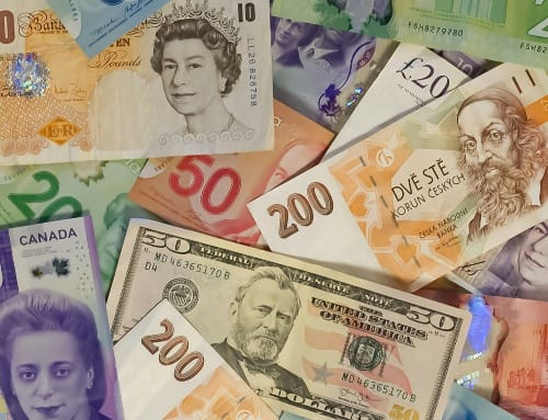 Stacks of international banknotes from around the world — money mindset and prosperity energy
