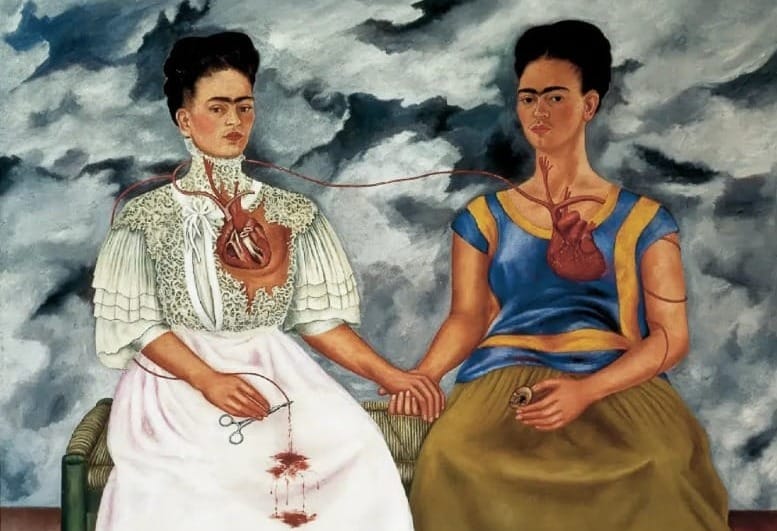 Frida Kahlo’s painting The Two Fridas (1939), depicting two seated self-portraits holding hands, hearts exposed and connected by a vein against a stormy sky.