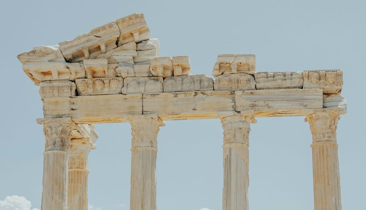 Ancient stone columns of the Temple of Apollo against open sky