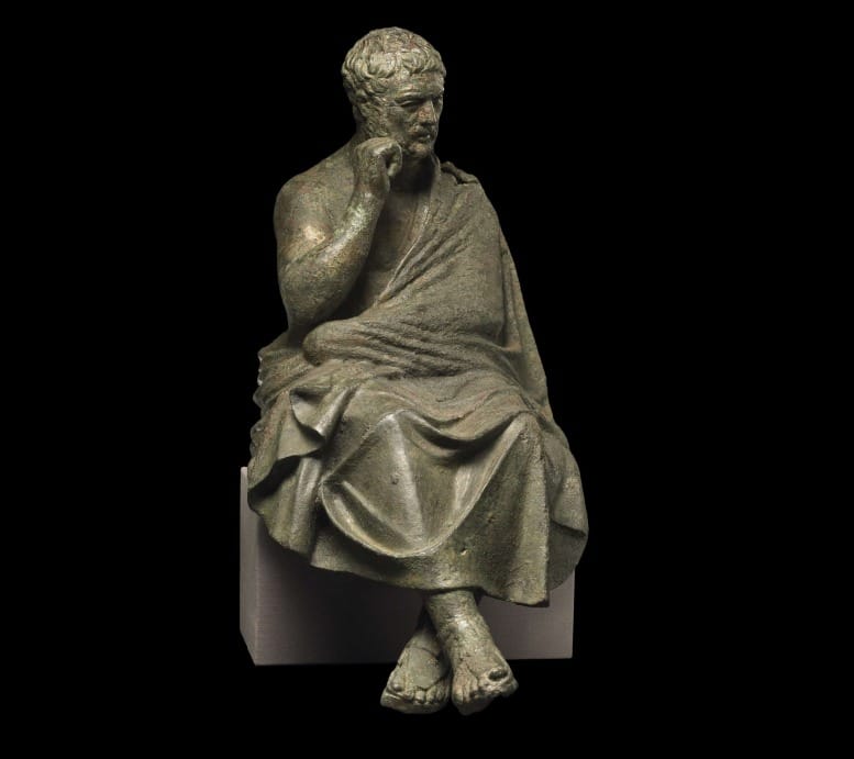 Bronze figure of a seated philosopher in stillness