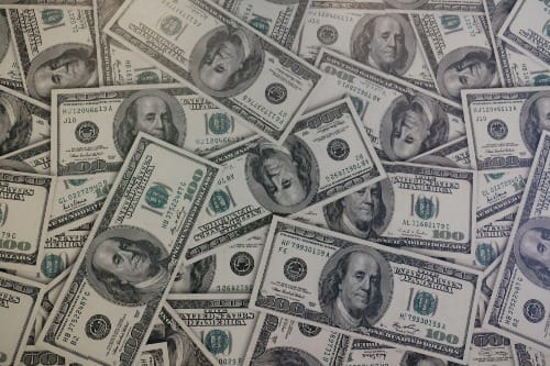 Stacks of $100 US dollar bills symbolizing manifestation, belief, and Law of Attraction wealth