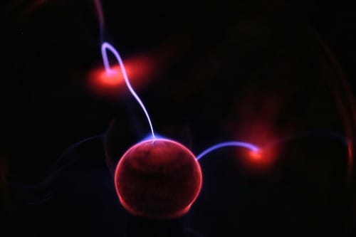 Pink plasma ball glowing with electric arcs — quantum leap manifestation energy and high-vibration alignment.
