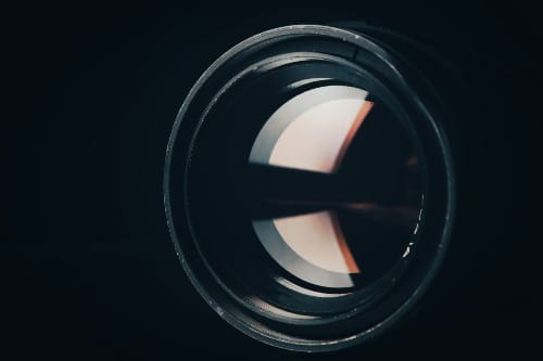 Image of a crystal lens refracting light into different perspectives to manifest the desired reality. 