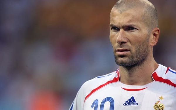Zinedine Zidane standing calmly on the pitch, embodying presence, composure, and inner control during a football match.