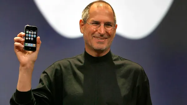 Steve Jobs presenting the iPhone at Apple keynote showcasing innovation and vision